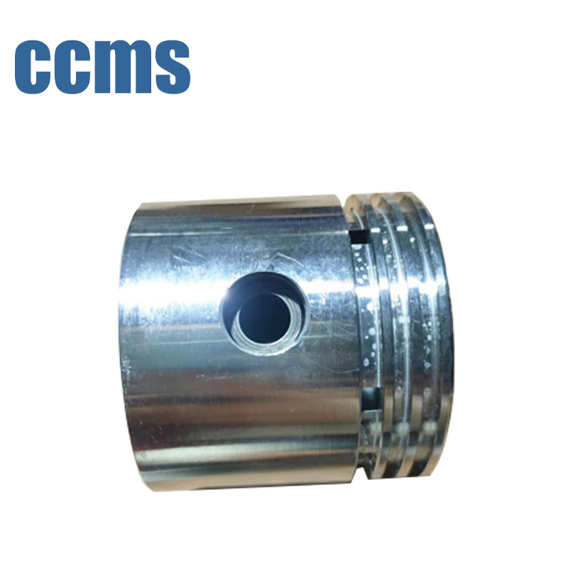 CCMS machined piston with ring grooves, crown features and cross hole